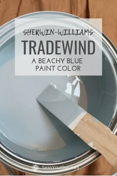 a paint can with the words shewn williams tradewind on it and a wooden spatula