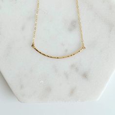 The Sophie necklace features a curved bar pendant that is crafted from 14k gold filled metal with a textured finish that catches the light beautifully. It is the perfect accessory for both elegant and everyday occasions, and great for layering. The unique, sparkly design ensures it won't go unnoticed. -- cable link chain hammered bar: 1.5" necklace lengths: 16 and 18 inches 14k Gold Filled and sterling silver Curved Bar, Bar Pendant, Bar Necklace, Link Chain, Gold Filled, Necklace Lengths, Layering, Cable, Bar