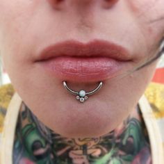 a woman with piercings on her neck and nose