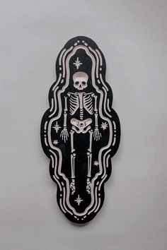 a black and white sticker with a skeleton on it's back in the shape of a frame