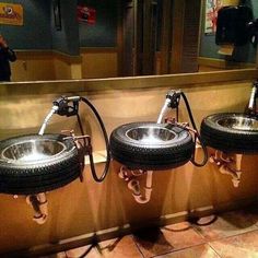 three sinks with wheels on them in a bathroom