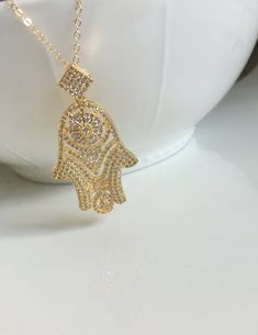 "Beautiful Pave Gold Hamsa Necklace Why Hamsa jewelry is so popular as a symbol of protection.  Hamsa necklaces, bracelets or rings ward off evil eye. Perfect Graduation Gift. Best Friend Gift Hamsa measures approx - 25mm x 50mm - gold over brass Chain - Sturdy 14kt Gold Filled  -How to Order  Please select the length from the drop down menu The standard length is normally 18\". For multiple necklace purchases please send us a quick email for pricing and availability -Questions  All of our jewel Ward Off Evil Eye, Long Necklace Gold, Hamsa Necklace Gold, Pendant Necklace Long, Double Horn Necklace, Hamsa Jewelry, Gold Hamsa, Hamsa Pendant, Hamsa Necklace