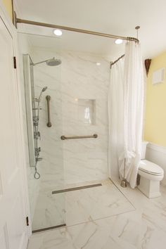 a bathroom with a shower, toilet and sink in it's center area is shown