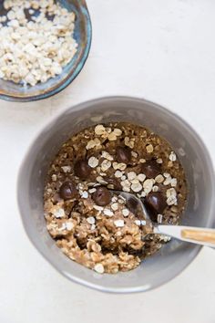 two bowls filled with oatmeal, chocolate and nuts next to each other