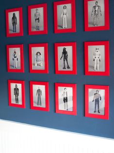 a blue wall with red frames and pictures of people in different outfits on it's sides