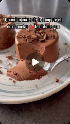 two pieces of chocolate cake on a white plate with a spoon in front of it