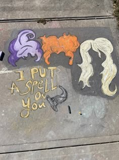 some chalk drawings are on the sidewalk with words written in different colors and shapes that spell out, i put aspell on you