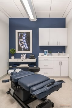 a room with blue and white furniture in the center, including a reclining chair