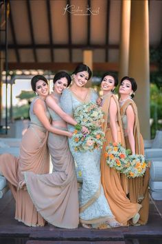 the bride and her bridesmaids pose for a photo