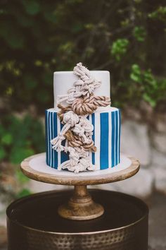 a blue and white wedding cake on top of a table