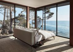 a living room with large windows overlooking the ocean