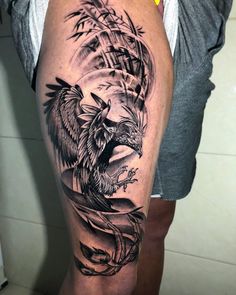 a man's thigh with an eagle tattoo on it