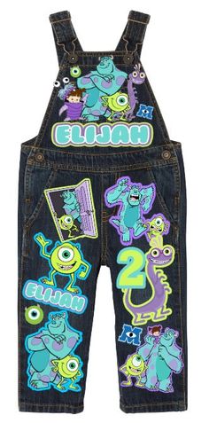 a pair of children's denim overalls with monsters on the front and back