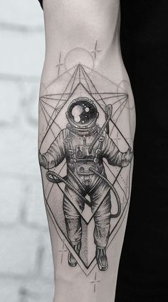 a man's leg with an astronaut tattoo on it