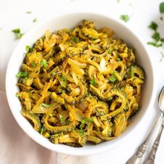 a white bowl filled with pasta and broccoli