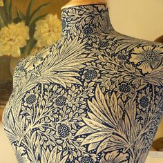 a blue and white vase sitting on top of a table