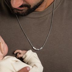 This classic stainless steel necklace for dad is the perfect way to keep your loved ones close to his heart. The custom rectangle beads can be personalized with your kids' names, making it a truly meaningful gift. Each bead is carefully hand-stamped with precision and care, creating a unique and sentimental piece that dad will cherish for years to come. This necklace is a timeless and stylish accessory that is sure to make a thoughtful and memorable gift for any occasion. Whether it's a gift for Father's Day, a birthday, Christmas or just to show your appreciation, this Dad Necklace with Kids' Names is the ultimate symbol of love and family. Length: 24" (61cm). Thickness: 2.5mm Engraving palette size: 10*4 mm Color: Available in silver and black versions. Water proof Every purchase comes p Cheap Silver Name Necklace For Father's Day, Dad With Kids, Necklace With Kids Names, Family Jewelry, Father Gift, Kids Names, Family Jewellery, Steel Necklace, Love Symbols