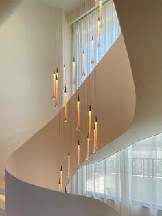 a spiral staircase with lights hanging from it