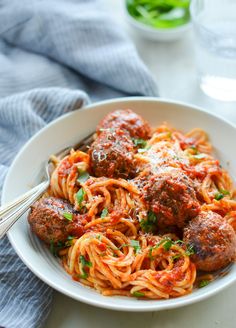 a plate of spaghetti and meatballs on a table