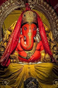 a statue of an elephant with a red cloth draped over it's head and eyes