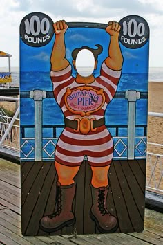 a cardboard cutout of a man on a deck with the ocean in the background