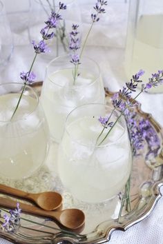 lavender water in glasses and wooden spoons on a tray