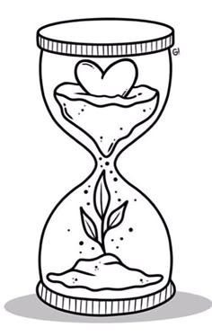 an hourglass filled with sand and a heart shaped plant in the middle, on top of