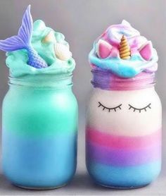 there are two jars that have unicorns on them and one is blue, the other has