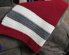 a crocheted pillow sitting on top of a couch