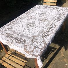 an old table is covered with white lace