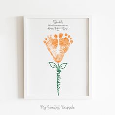 an orange handprinted flower with the words daddy written in green ink on it