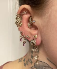 a woman with tattoos and piercings on her ear