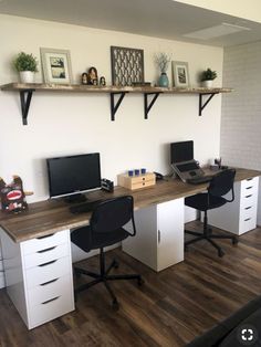 an office with two desks and three computer monitors