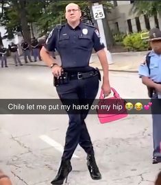 a police officer standing in the middle of a street holding a pink purse and talking to someone else