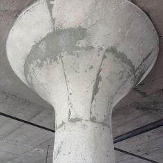 the top of a cement pillar in a building