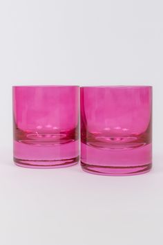 two pink glasses sitting next to each other