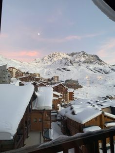 snow covered mountains and buildings in the distance