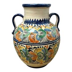 an ornate vase with blue handles and floral designs on it's sides, against a white background