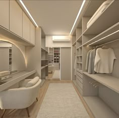 an empty walk in closet with white furniture