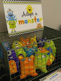 some stuffed animals in a cage with a sign above them that says adopt a monster