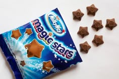 a bag of chocolate stars next to it's contents on a white table top