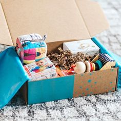 an open box filled with toys on top of a carpet