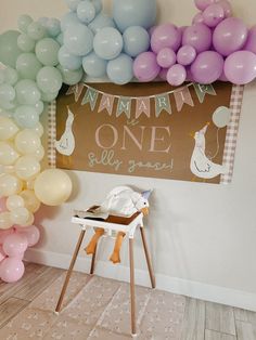 a baby's first birthday party with balloons and decorations