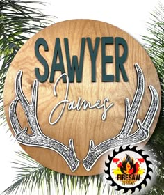 a wooden sign that says sawer james with deer antlers on it's side