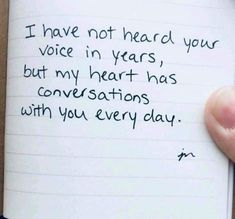 someone holding up a note that says i have not heard your voice in years but my heart has conversations with you every day