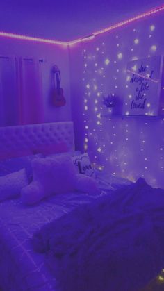 a bedroom with purple lights on the walls