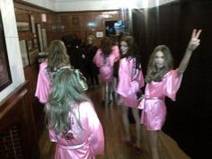 the girls are dressed in pink robes