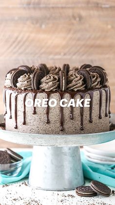 an oreo cookie cake with chocolate frosting and cookies on the side, ready to be eaten