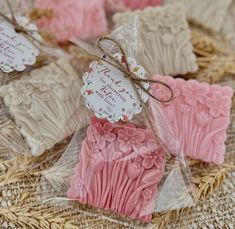 some pink and white cupcakes wrapped in plastic