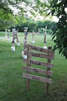 a wooden sign that says take a walk through the year and is in front of some trees